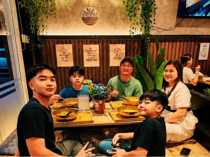 A family sharing gold hotpots at the floor-seating table at K-Stop